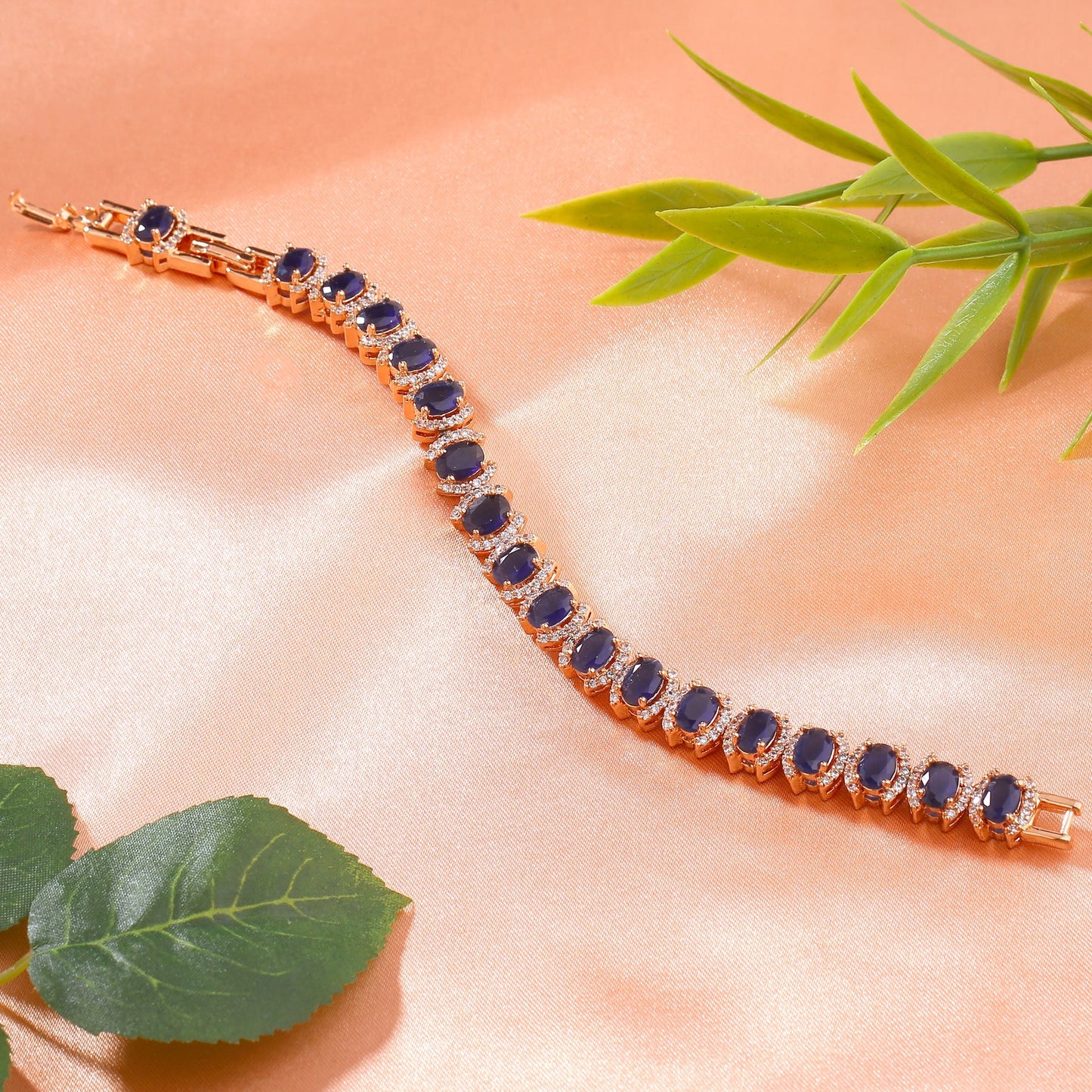 Estele Rose Gold-Polished CZ Ravishing Oval Designer Charm Bracelet with Blue American Diamonds for Women - Swadesiicart