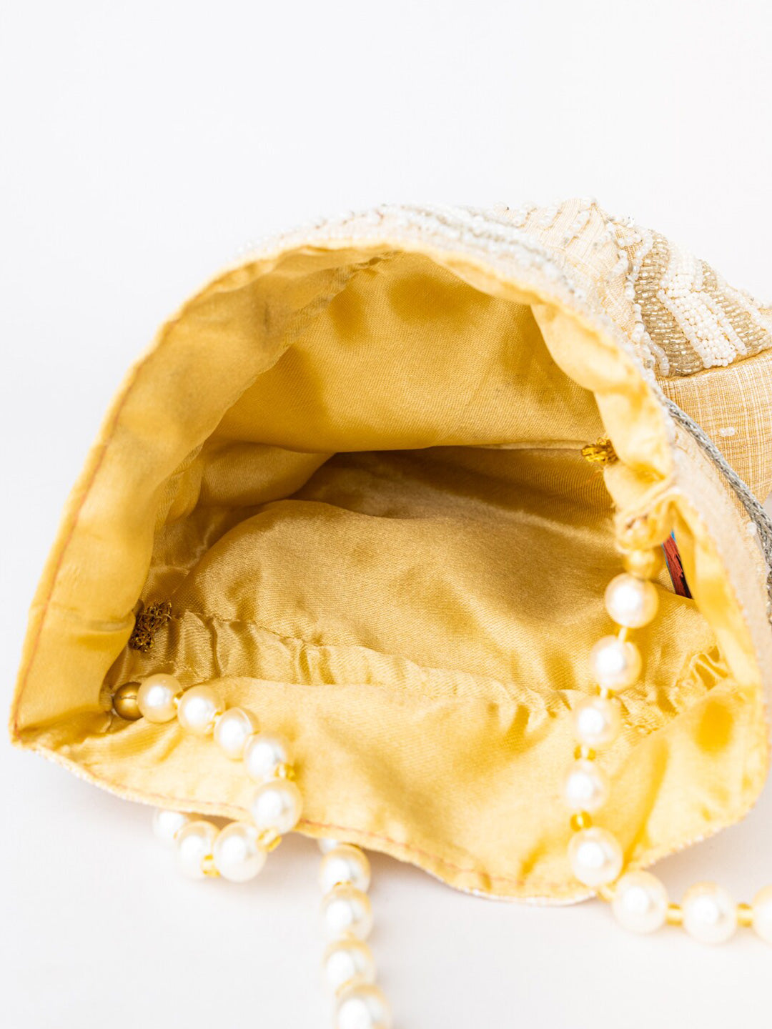 NR By Nidhi Rathi Cream-Coloured & Gold-Toned Embellished Potli Clutch - Swadesiicart