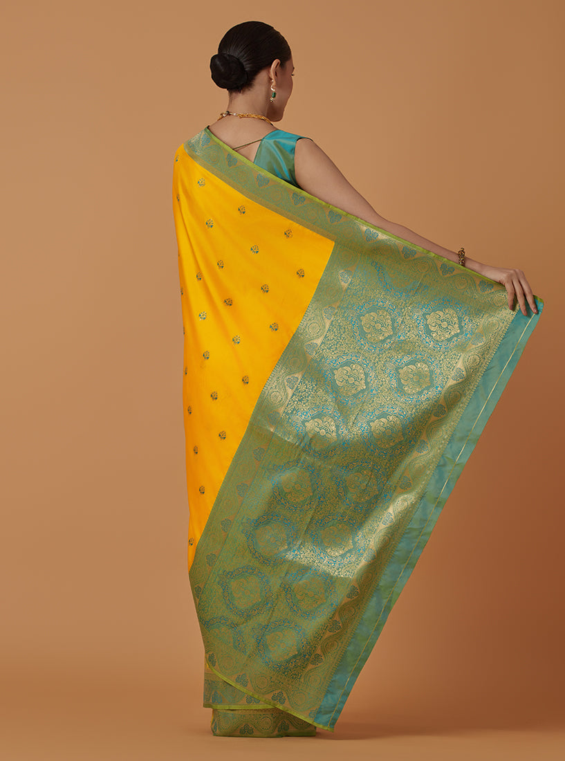 Monjolika Fashion Yellow Banarasi Silk Blend SareeWith Traditional & Modern Dulha Dulhan Figure Zari Woven Detailing | Swadesiicart
