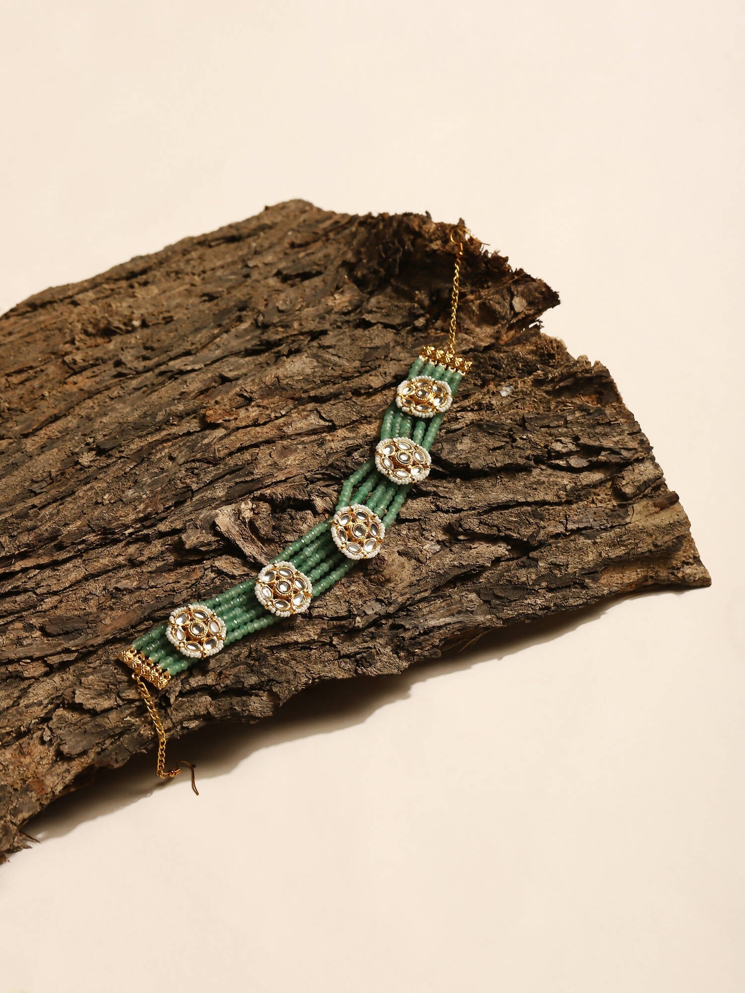 Gold-Polished Green Kundan Studded Headband - Ruby Raang | Swadesiicart