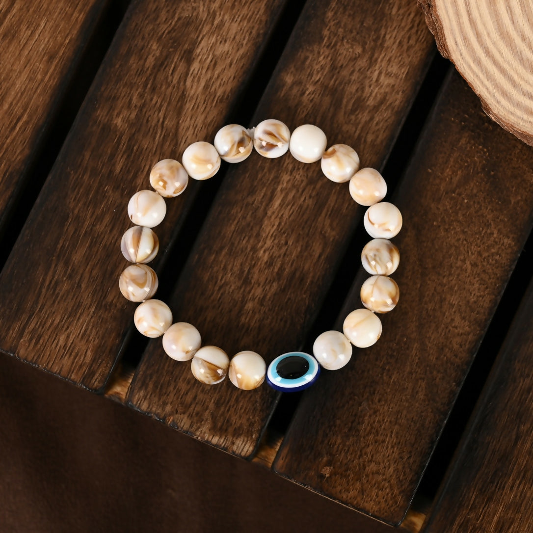 NVR Women & Men Cream-colored Evil Eye Elasticated Rakhi With Roli Chawal - NR Retail-NVR