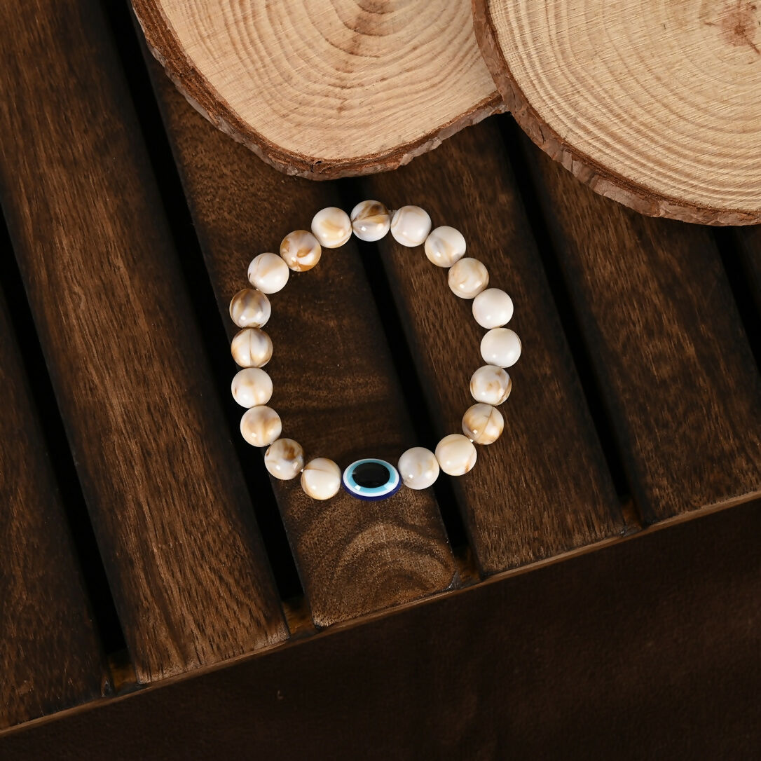 NVR Women & Men Cream-colored Evil Eye Elasticated Rakhi With Roli Chawal - Swadesiicart