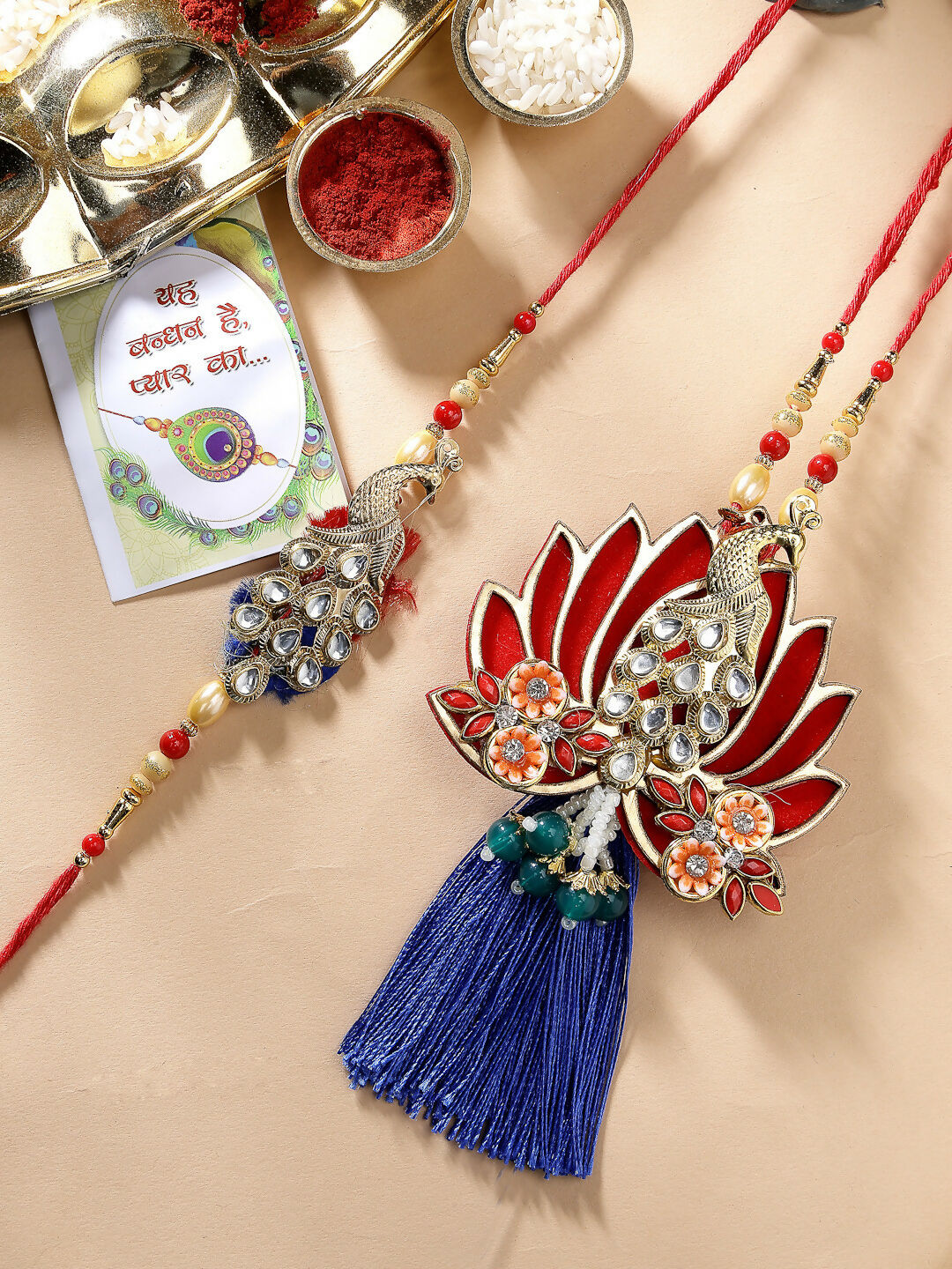 NVR Women & Men Set of 2 Gold-Toned Peacock Design Stone-Studded Bhaiya Bhabhi Rakhi With Roli Chawal | Swadesiicart