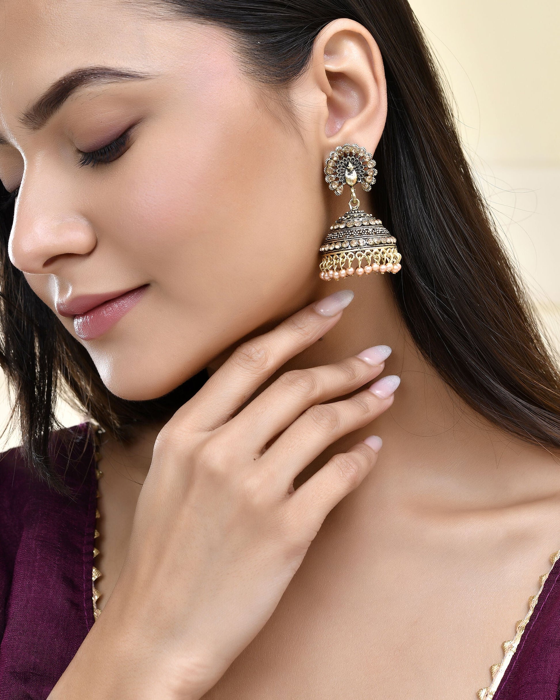 Jewels Nest Antique Gold-Polished Jhumka Earrings with Floral Detailing and Stone Embellishments - Swadesiicart