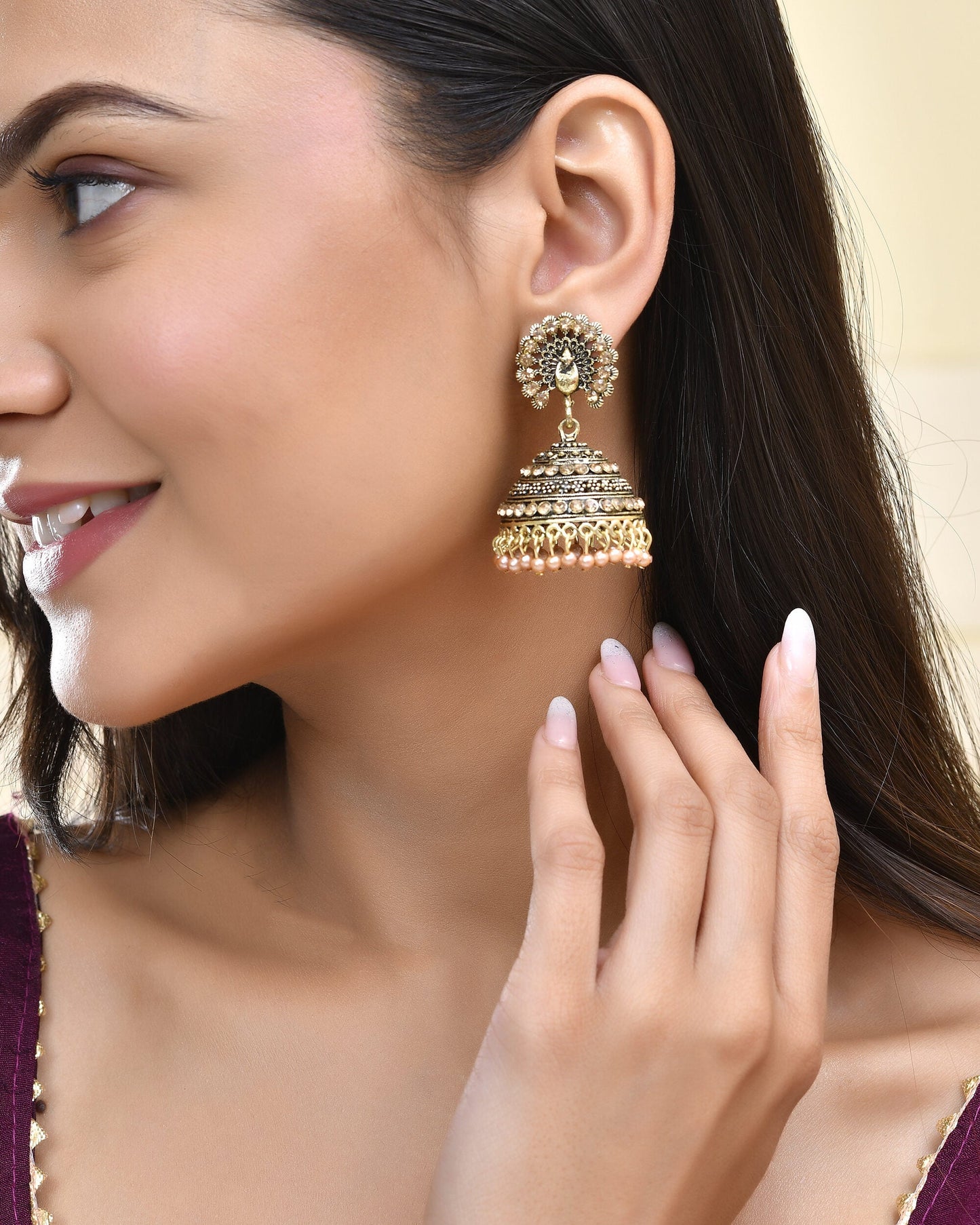 Jewels Nest Antique Gold-Polished Jhumka Earrings with Floral Detailing and Stone Embellishments - Swadesiicart