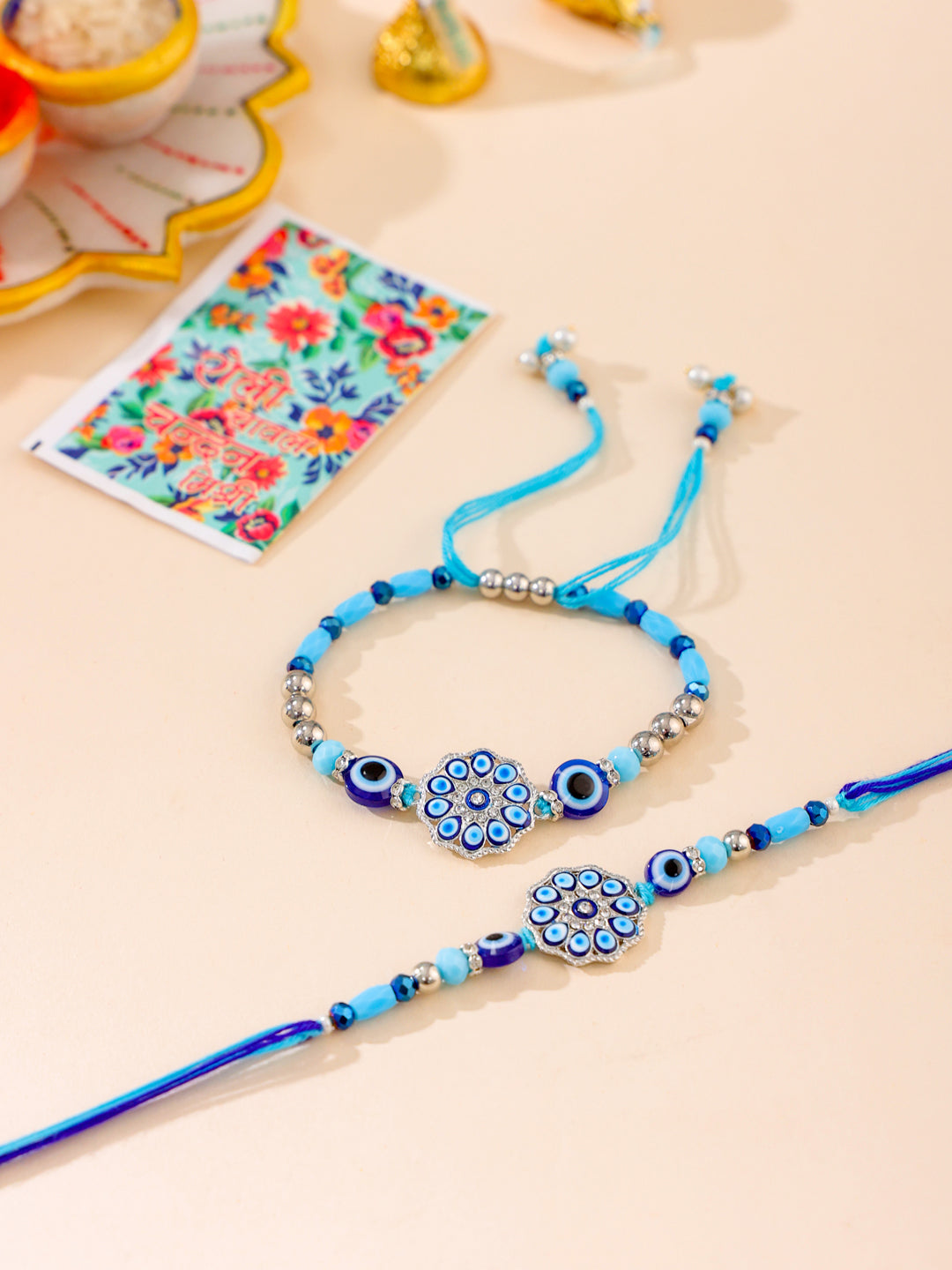 NVR Set of 2 Blue Evil Eye Floral Design Bhaiya Bhabhi Rakhi with Roli Chawal Chandan & Mishri | Swadesiicart