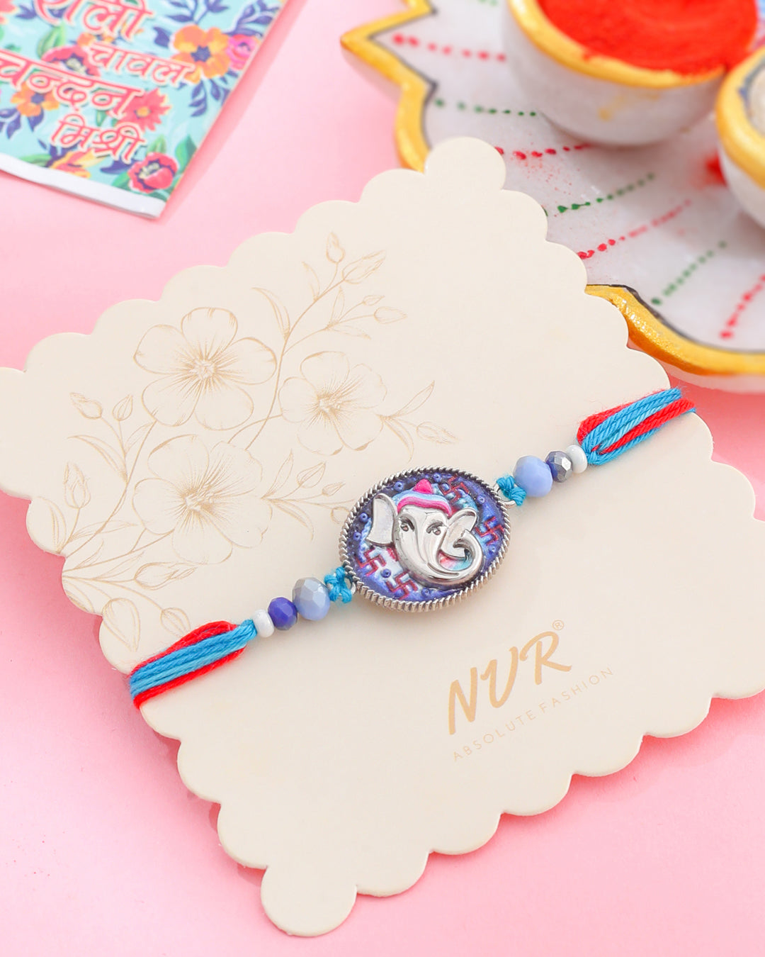 NVR Men Red & Blue Ganesh Ji Thread Rakhi with Roli Chawal Chandan & Mishri - Swadesiicart