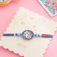 NVR Men Red & Blue Ganesh Ji Thread Rakhi with Roli Chawal Chandan & Mishri - Swadesiicart