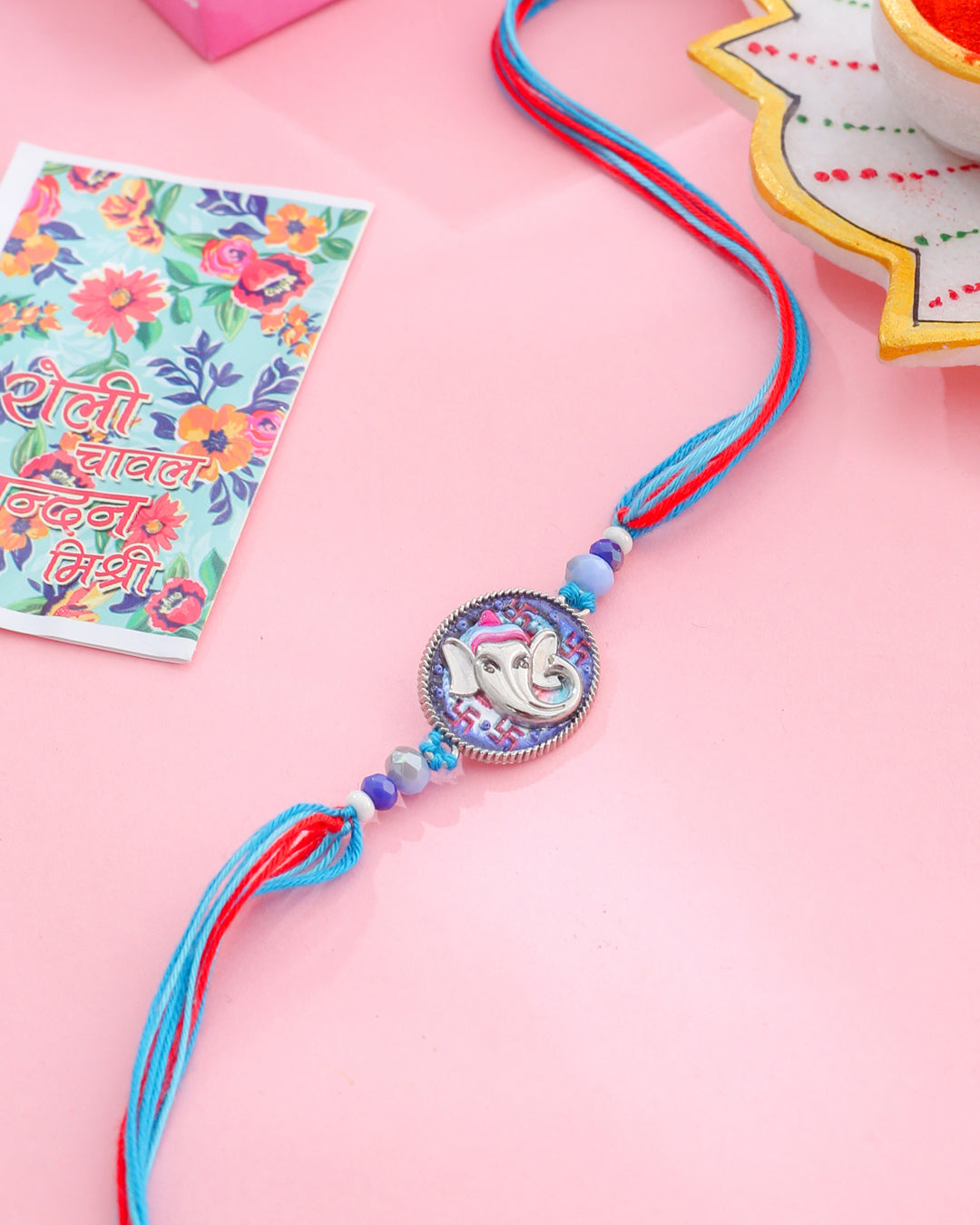 NVR Men Red & Blue Ganesh Ji Thread Rakhi with Roli Chawal Chandan & Mishri - Swadesiicart