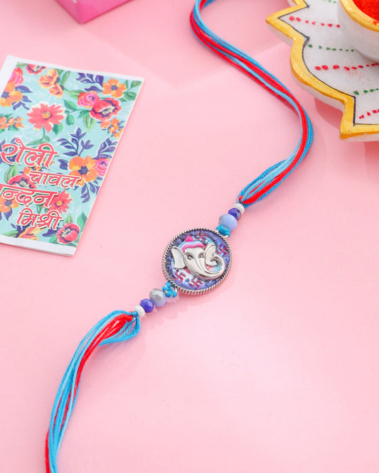 NVR Men Red & Blue Ganesh Ji Thread Rakhi with Roli Chawal Chandan & Mishri - Swadesiicart