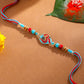 NVR Men Red & Blue Artificial Stones and Beads Om Thread Rakhi with Roli Chawal Chandan & Mishri - Swadesiicart