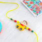 NVR Kids Yellow Cartoon Artificial Beads Rakhi with Roli Chawal Chandan & Mishri | Swadesiicart