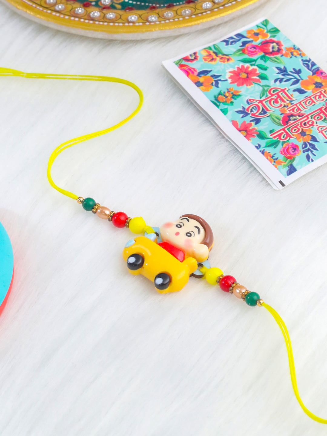NVR Kids Yellow Cartoon Artificial Beads Rakhi with Roli Chawal Chandan & Mishri | Swadesiicart