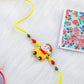 NVR Kids Yellow Cartoon Artificial Beads Rakhi with Roli Chawal Chandan & Mishri | Swadesiicart