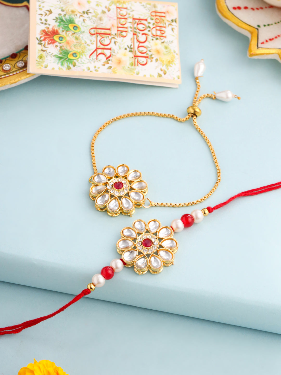 NVR Set of 2 Gold Toned Kundan Studded Floral Design Bhaiya Bhabhi Rakhi Set with Roli Chawal Chandan & Mishri | Swadesiicart