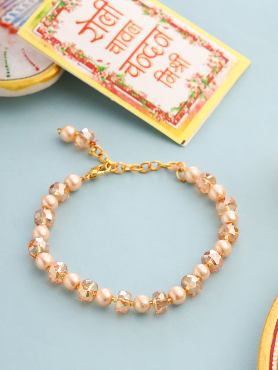 NVR Women Gold Toned Artificial Beads Wraparound Rakhi with Roli Chawal Chandan & Mishri - Swadesiicart