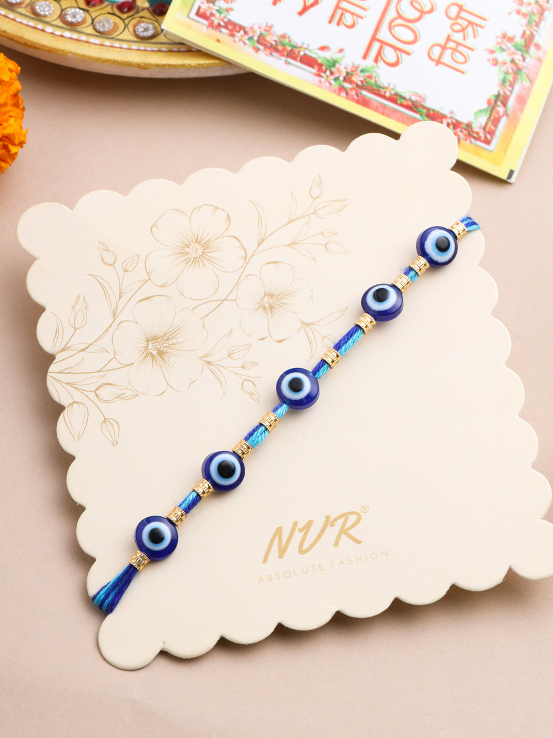 NVR Men's Blue Evil Eye Thread Rakhi with Roli Chawal Chandan & Mishri - Swadesiicart