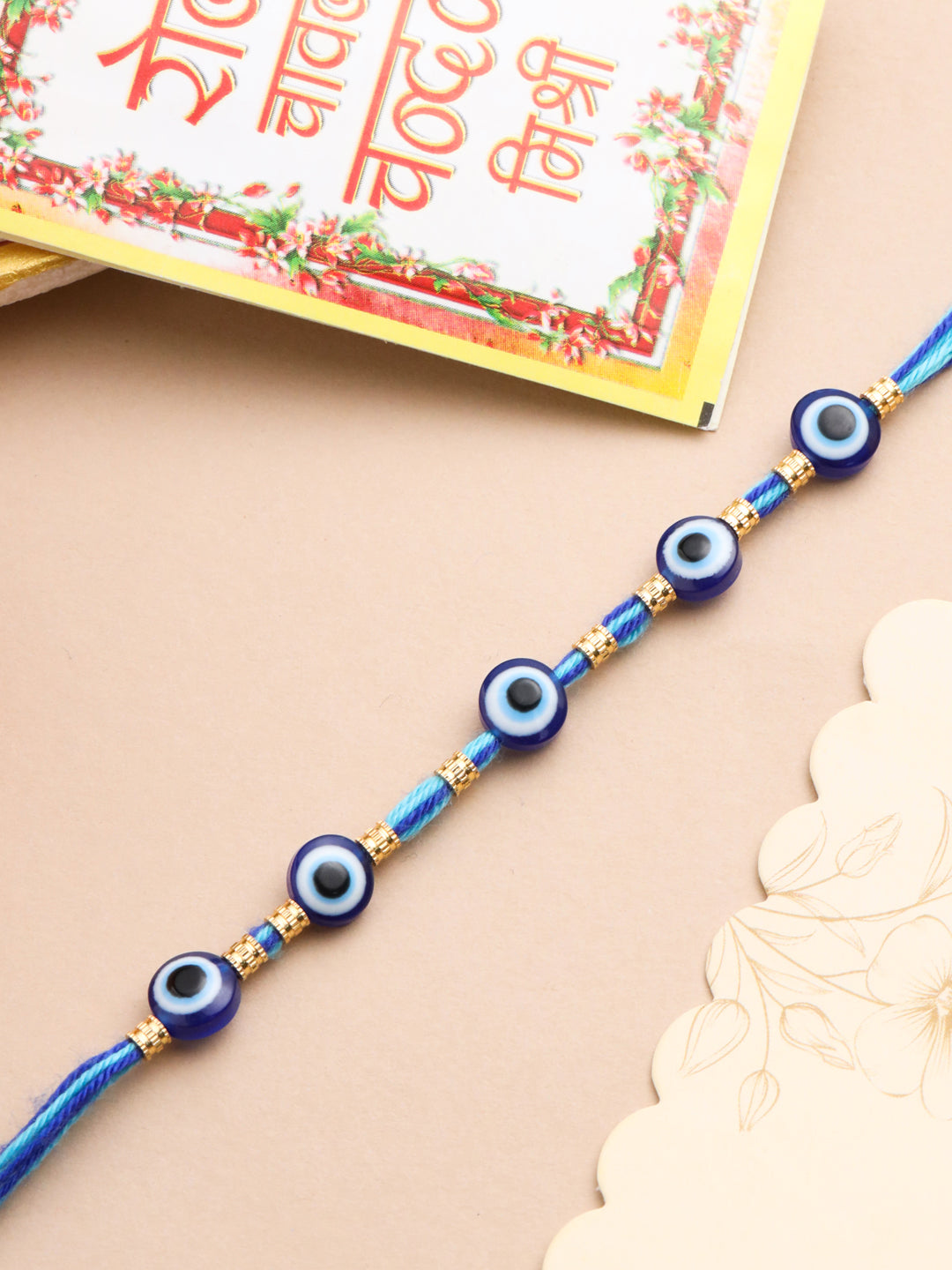 NVR Men's Blue Evil Eye Thread Rakhi with Roli Chawal Chandan & Mishri - Swadesiicart