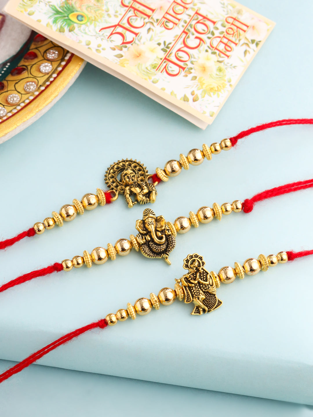NVR Men Set of 3 Gold Toned Designer Ganesh Ji Thread Rakhi with Roli Chawal Chandan & Mishri - Swadesiicart