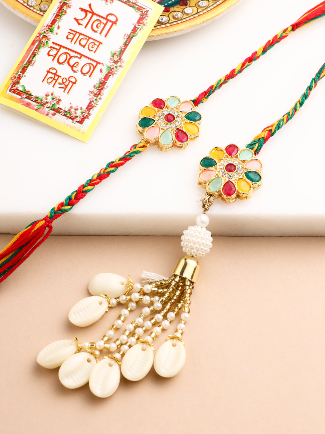 NVR Set of 2 Artificial Beads & Sea Shell Floral Design Bhaiya Bhabhi Rakhi with Roli Chawal Chandan & Mishri | Swadesiicart