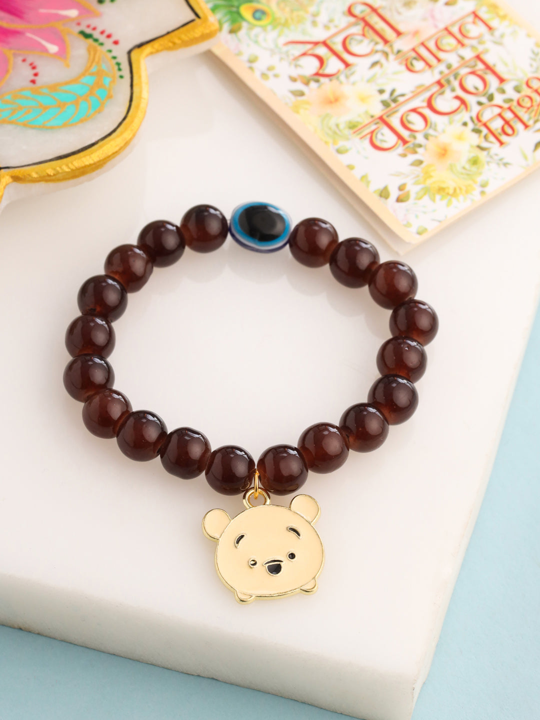 NVR Kids Cartoon Design Brown Artificial Beads Thread Rakhi with Roli Chawal Chandan & Mishri | Swadesiicart