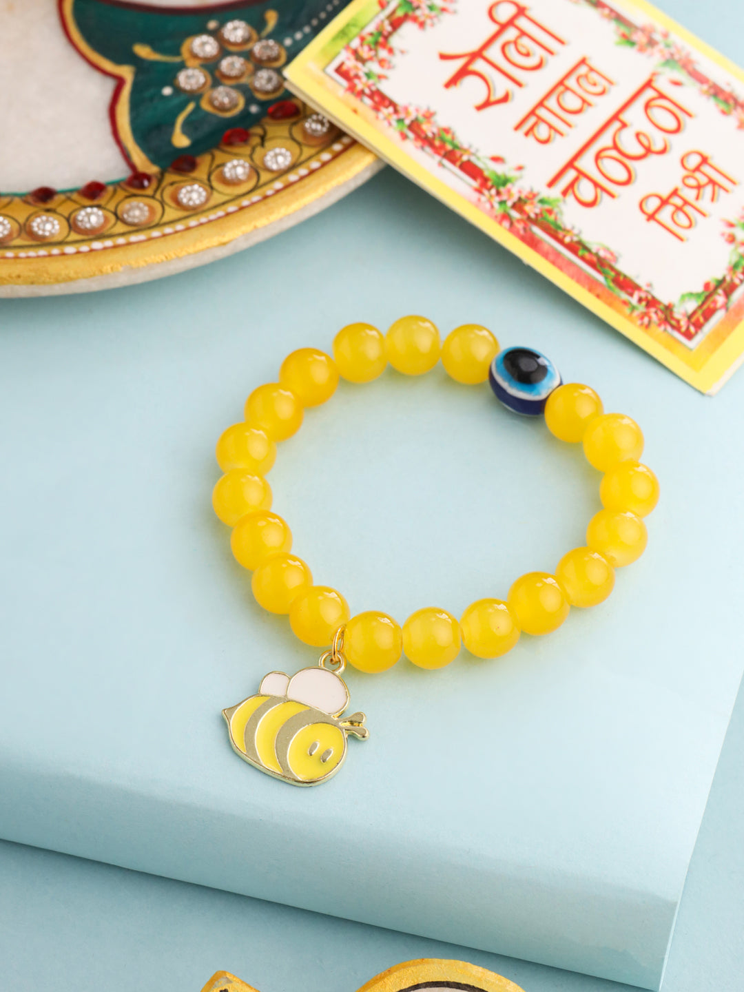 NVR Kids Cartoon Design Yellow Artificial Beads Thread Rakhi with Roli Chawal Chandan & Mishri | Swadesiicart