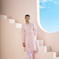 A Pink Sherwani Featuring Elegant Cross-Line Patterns Adorned With Intricate Floral Designs by Hilo Design