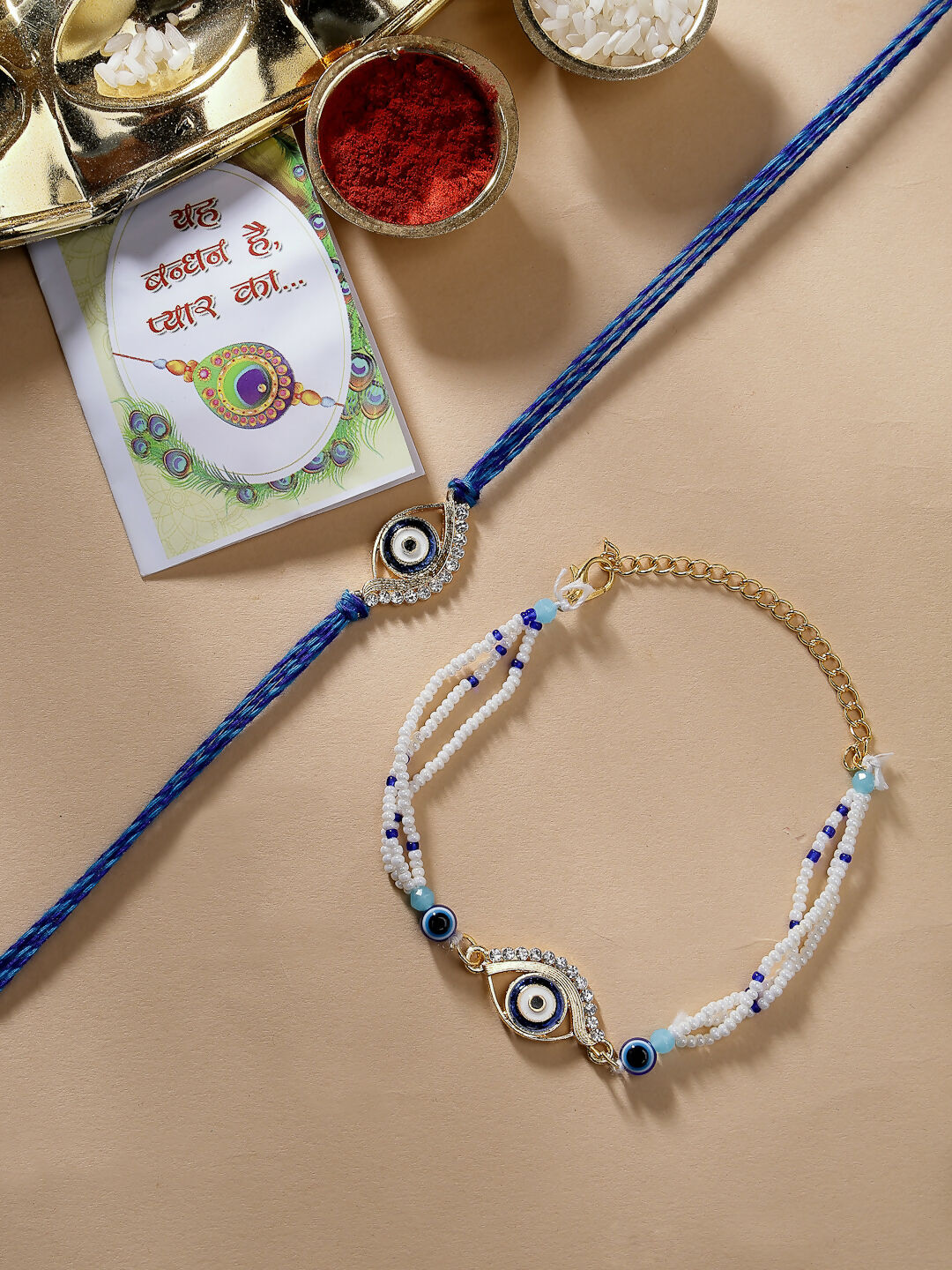 NVR Women & Men Set of 2 Blue Evil Eye Bhaiya Bhabhi Rakhi Set With Roli Chawal & Chocolate | Swadesiicart