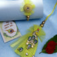 NVR Women & Men Set of 2 Yellow Peacock Design Bhaiya Bhabhi Rakhi With Roli Chawal & Chocolate | Swadesiicart