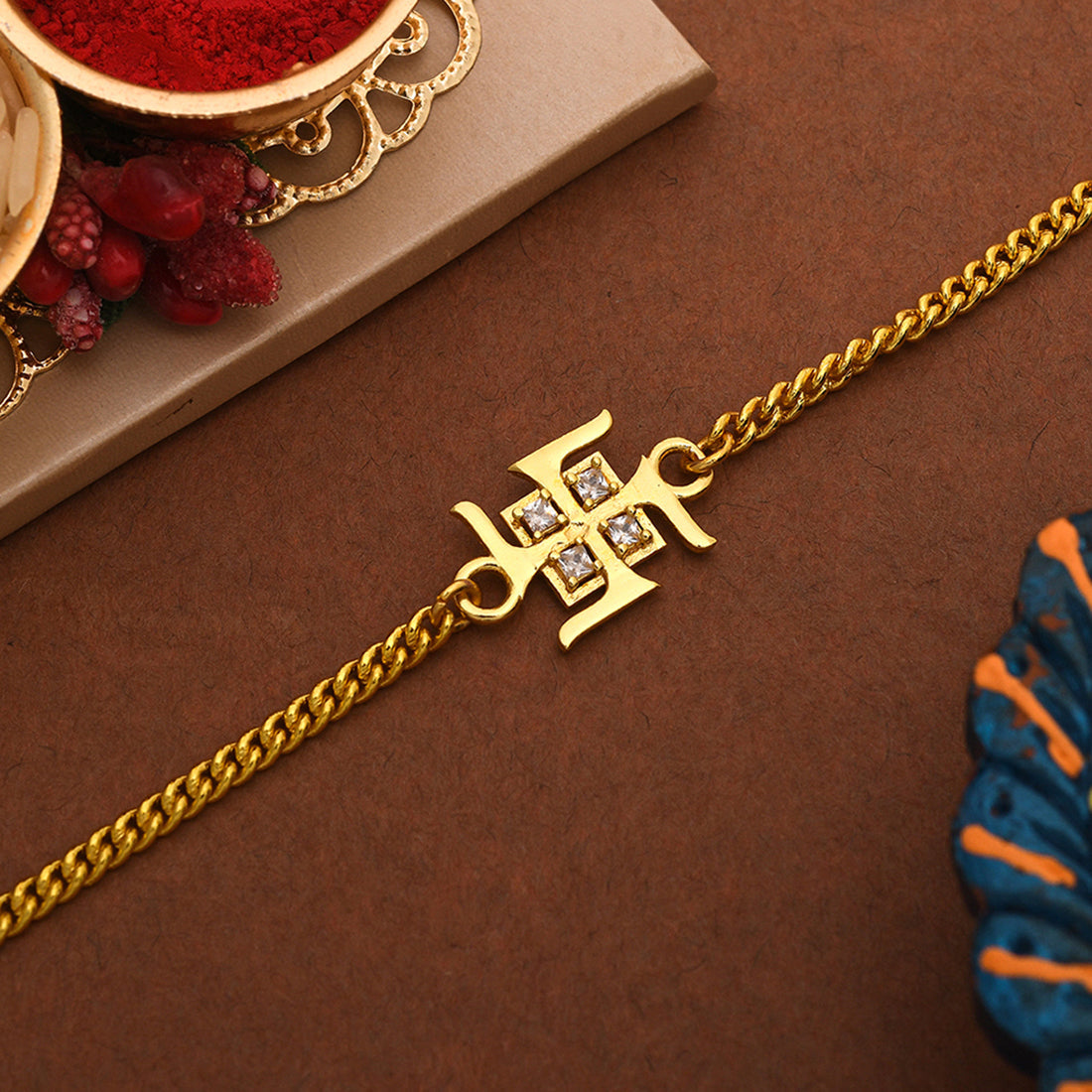 trueBrowns Auspicious Swastik Gold-Polished Bracelet Style Rakhi | Swadesiicart