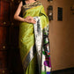 Very Much Indian Premium Handloom Pure Silk Muniya Borde-Parrot Green,Silver Zari And Intricate Big Radha Krishna Pallu | Swadesiicart