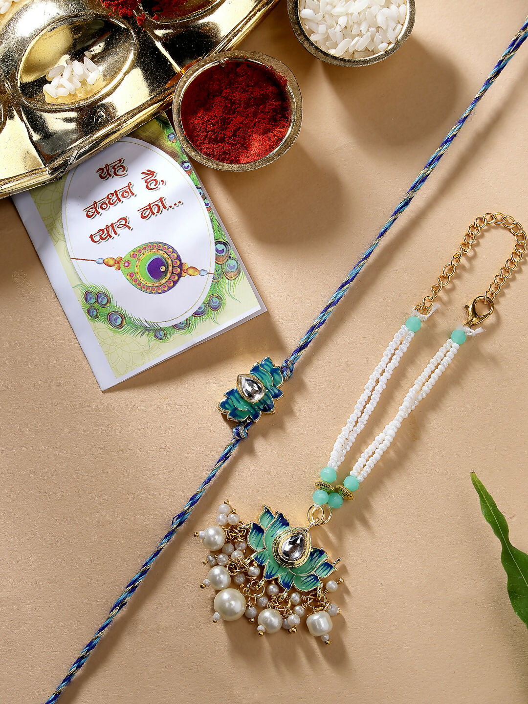 NVR Women & Men Set of 2 Turquoise Blue Lotus Shape Kundan-Studded & Beaded Rakhi Set With Roli Chawal & Chocolate | Swadesiicart