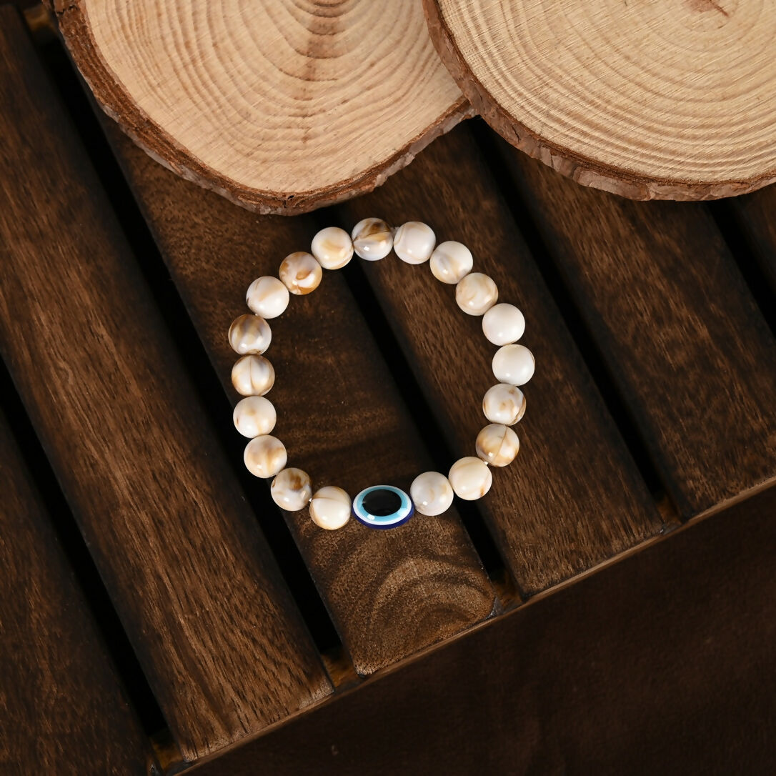 NVR Women & Men Cream-colored Evil Eye Elasticated Rakhi With Roli Chawal - Swadesiicart