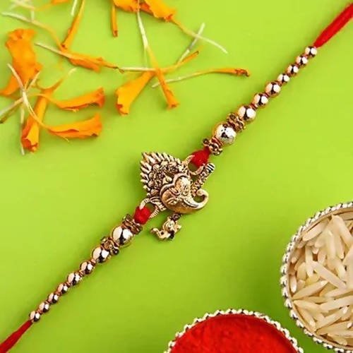 Auspicious Ganesha Rakhi And Kaju Rolls Box