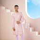 A Pink Sherwani Featuring Elegant Cross-Line Patterns Adorned With Intricate Floral Designs by Hilo Design