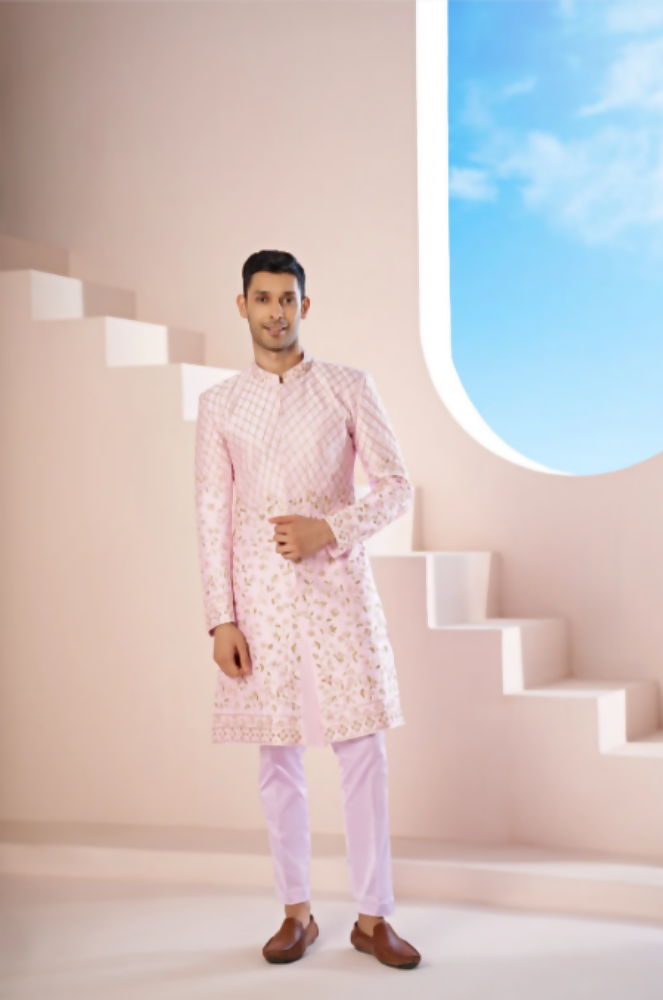 A Pink Sherwani Featuring Elegant Cross-Line Patterns Adorned With Intricate Floral Designs by Hilo Design