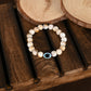 NVR Women & Men Cream-colored Evil Eye Elasticated Rakhi With Roli Chawal - Swadesiicart