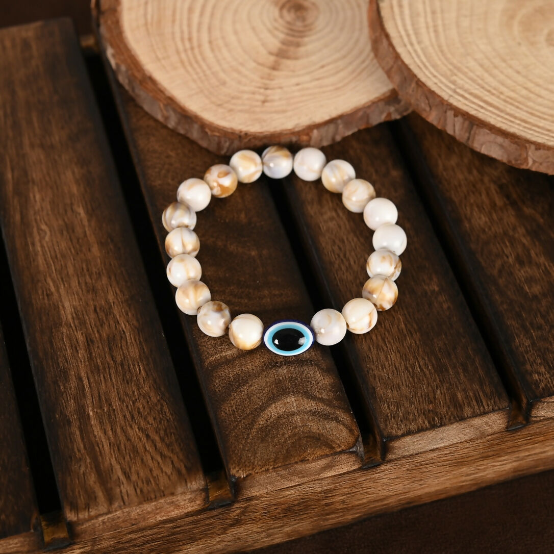 NVR Women & Men Cream-colored Evil Eye Elasticated Rakhi With Roli Chawal - Swadesiicart